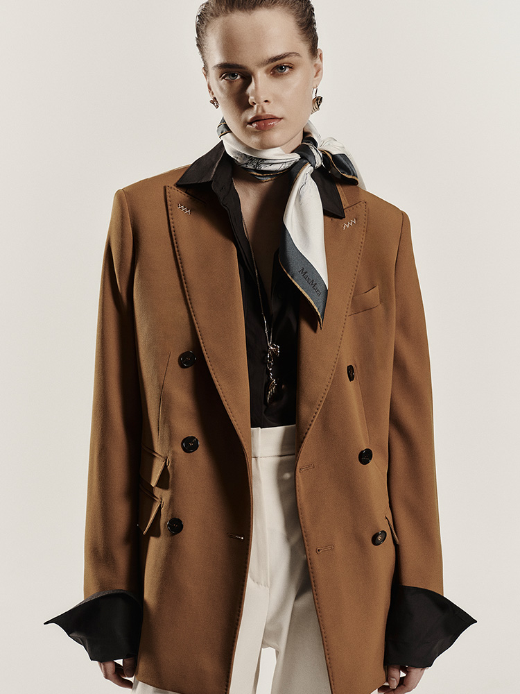 Model wears Max Mara Sartoriale double-breasted blazer in mustard-colour wool granite, with knotted foulard and shirt.